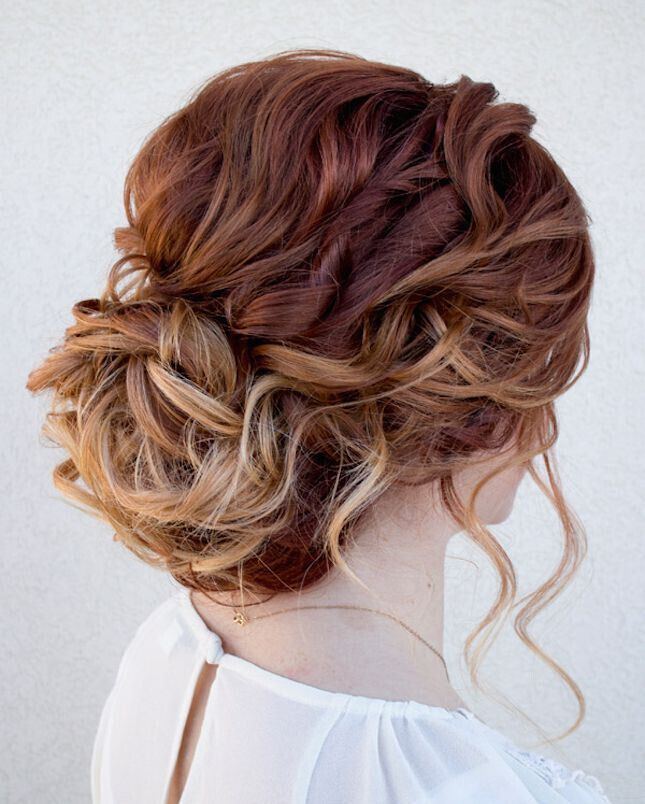 Curls gathered and pinned high in a formal 1920s updo