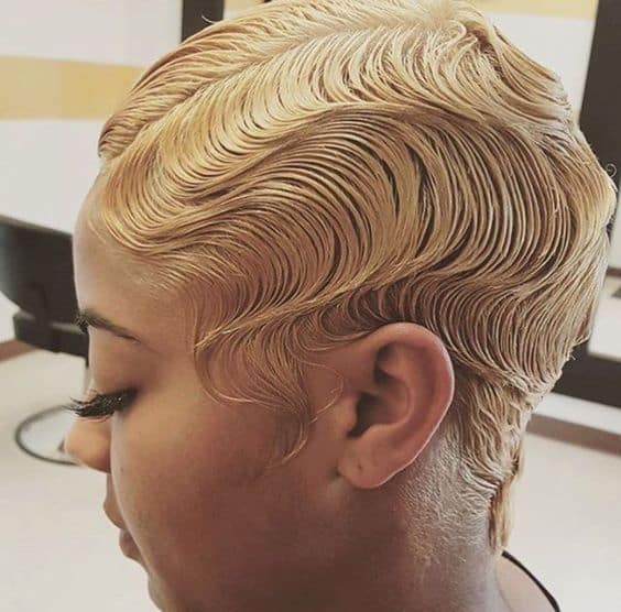 Close-set S-shaped finger waves molded flat against the head