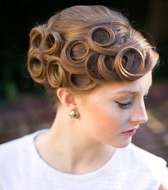 Brushed-out pin curl set falling in soft 1920s waves